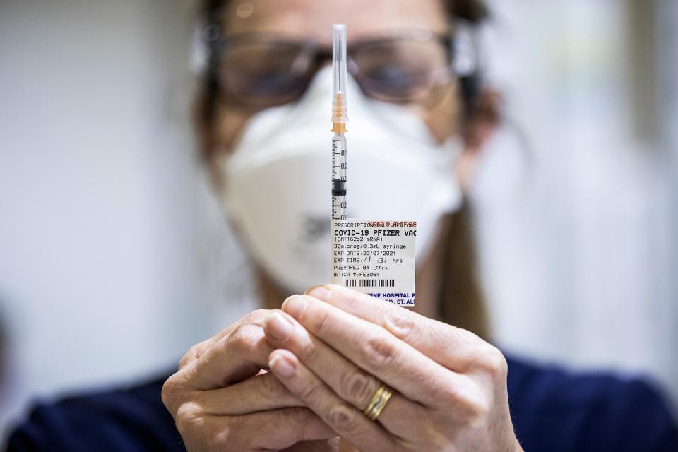 Staff are seen preparing Pfizer vaccine doses inside the Melbourne Showgrounds COVID-19 Vaccination Centre on July 20, 2021 in Melbourne, Australia