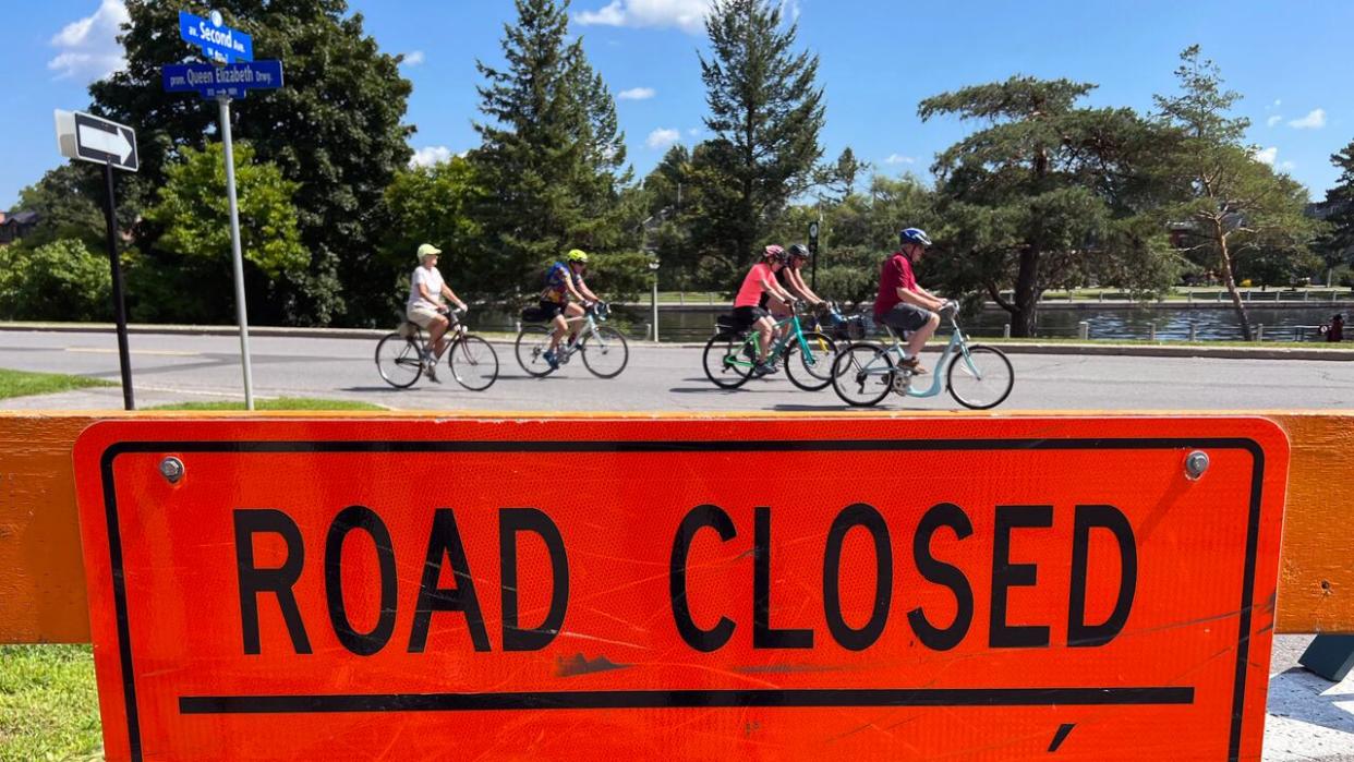 Cyclists ride down a section of Queen Elizabeth Driveway that was closed to vehicle traffic on Aug. 23, 2023. Last year the closures sparked a disagreement between the NCC and Ottawa's mayor. (Dan Taekema/CBC - image credit)