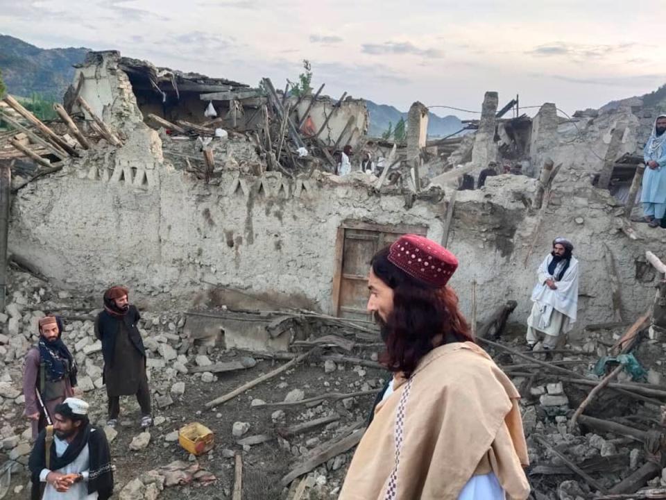 Locals look at the destruction caused by an earthquake in eastern Afghanistan (AP)