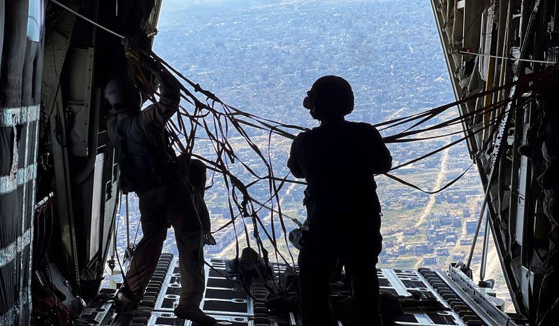 U.S. military personnel air drop aid parcels over Gaza