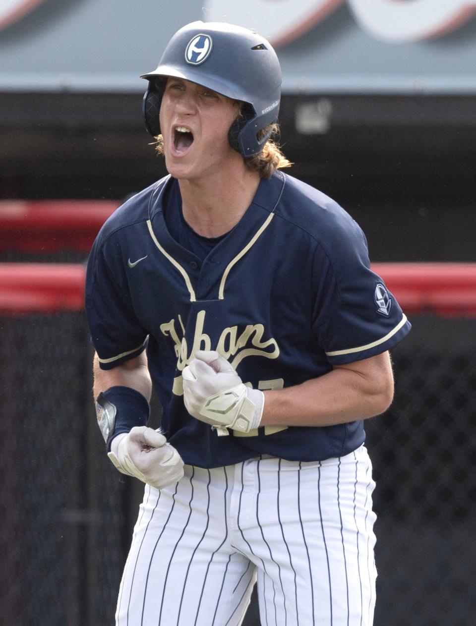 Hoban's Andrew Karhoff celebrates a first-inning run against Chardon during their Division I district semifinal at Munson Stadium in Canton on Tuesday, May 23, 2023.