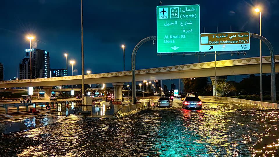Motorists drive along a flooded street in Dubai on April 17, 2024. - Giuseppe Cacace/AFP/Getty Images