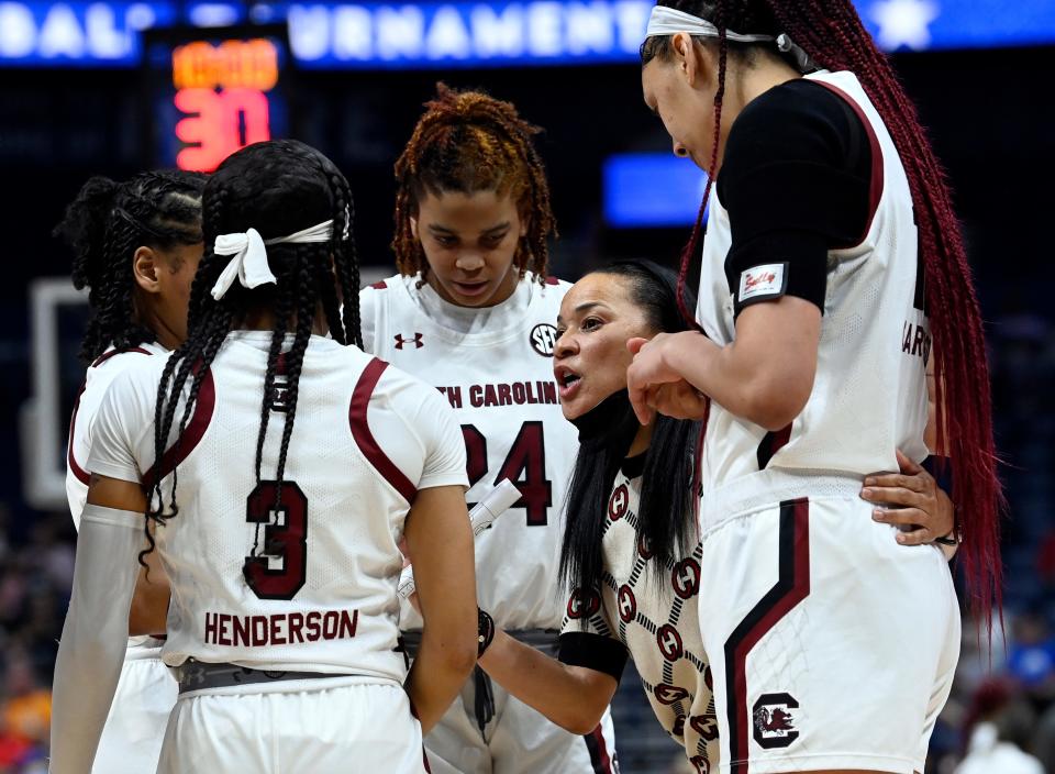 South Carolina head coach Dawn Staley talks with players during the first half of an NCAA college basketball semifinal game against Ole Miss, at the women’s Southeastern Conference tournament, Saturday, March 5, 2022, in Nashville, Tenn.