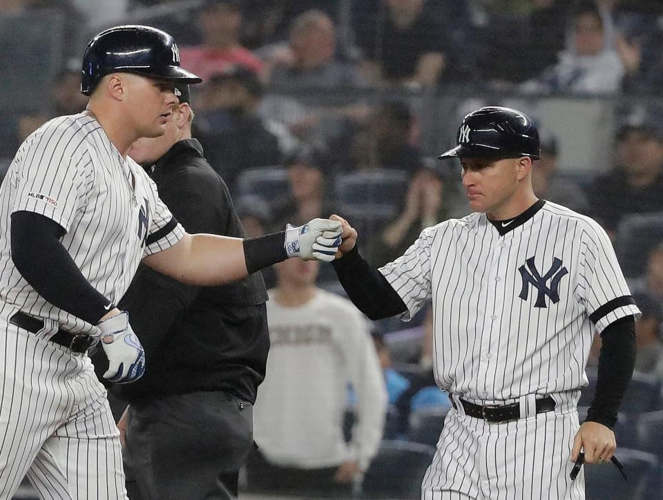 New  York Yankees slugger Luke Voit (left) celebrates an RBI single with then first-base coach Reggie Willits during a 2021 game at Yankee Stadium. Willits left the Yankees to become a volunteer assistant coach at Oklahoma.