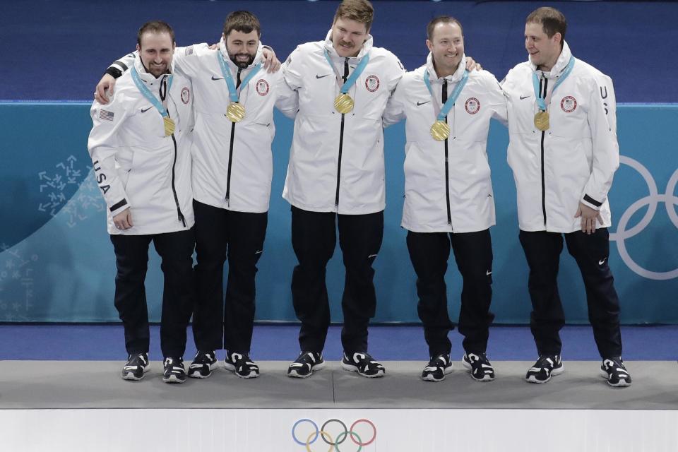 Medal mix-up: United States' curling team Joe Polo, John Landsteiner, Matt Hamilton, Tyler George and skip John Shuster smile after receiving their gold medals: AP