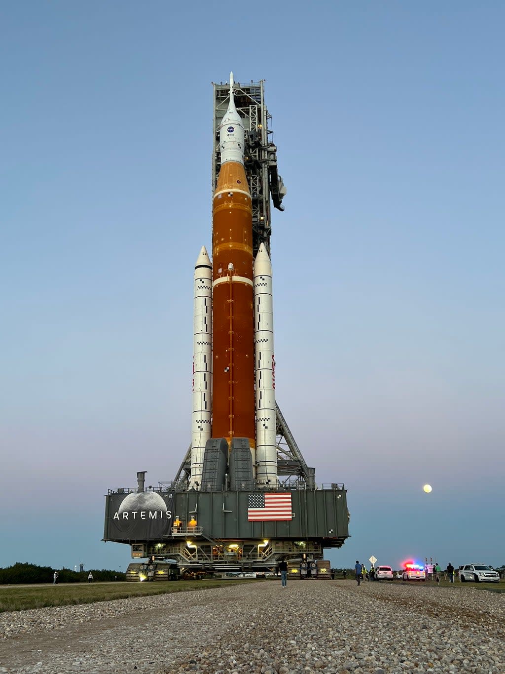 Nasa’s new Moon rocket, the Space Launch System, rolls to the launchpad under moonlight.  (Nasa)