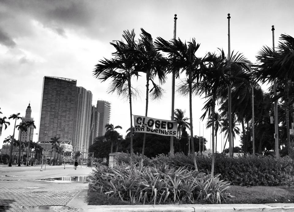 <p>A ripped “closed for business” sign hangs outside the Bayside Mall in downtown Miami. The mall, usually swamped with tourists, was closed amid an evacation order ahead of Hurricane Irma. (Photo: Holly Bailey/Yahoo News) </p>