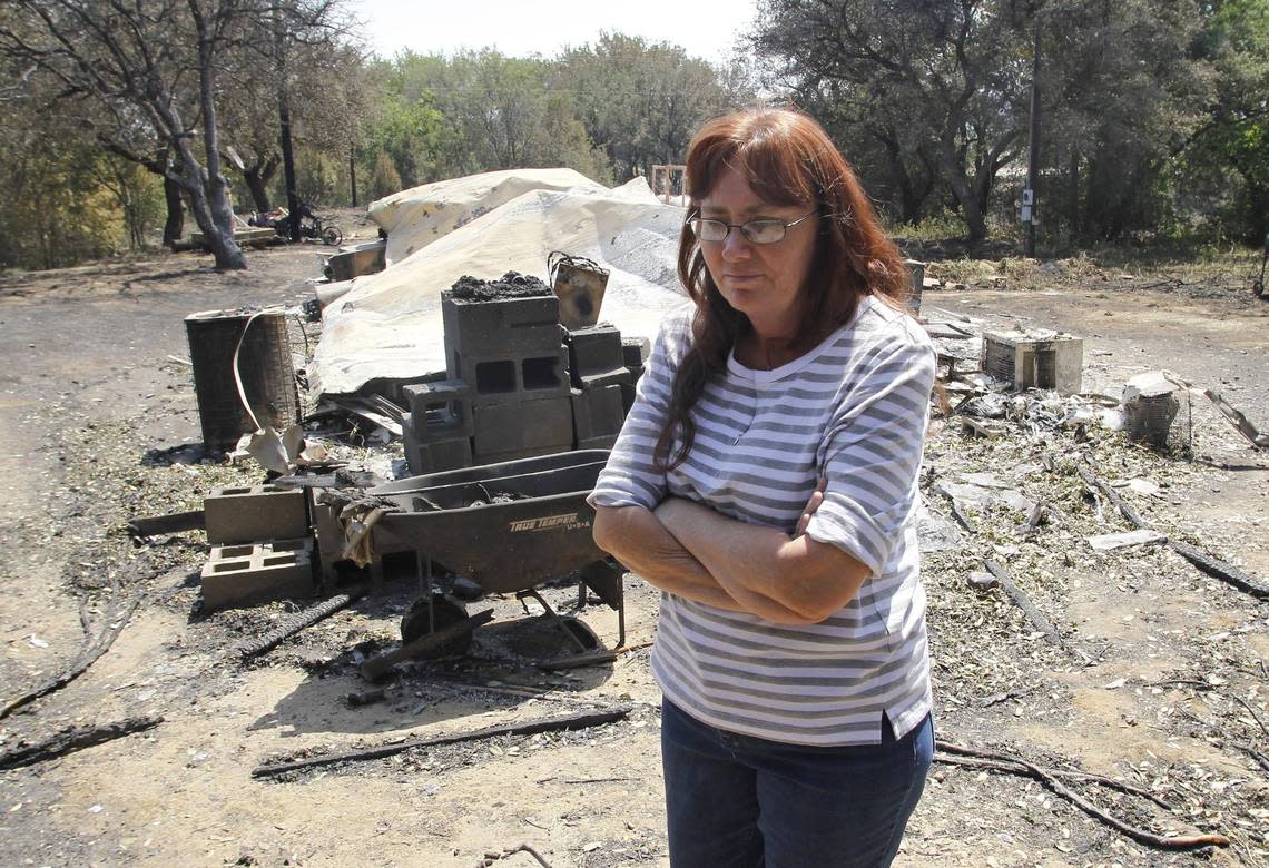 Linda Lanter walks away after her home burned down near Possum Kingdom Lake in April of 2011.