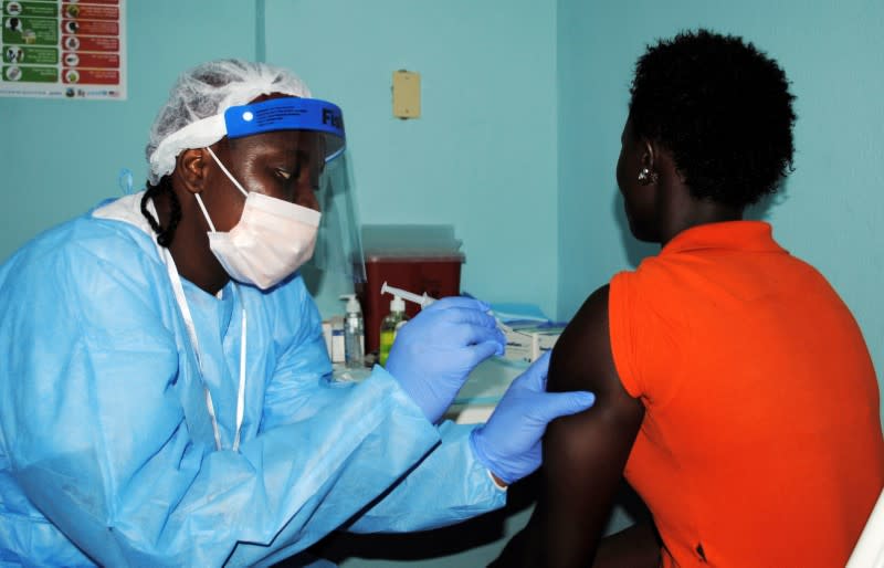 FILE PHOTO: Health worker injects a woman with an Ebola vaccine during a trial in Monrovia