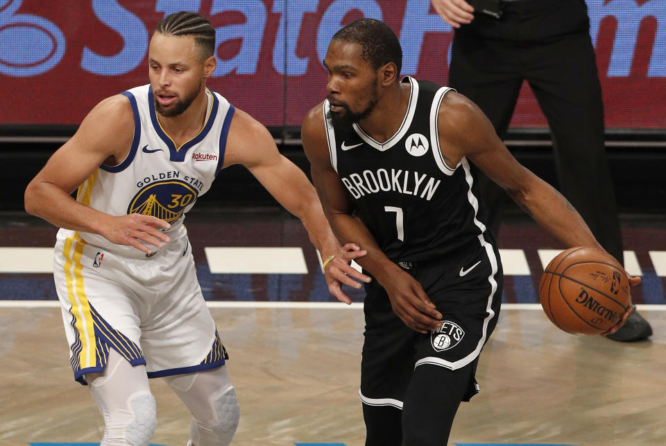 NEW YORK, NEW YORK - DECEMBER 22: (NEW YORK DAILIES OUT)  Kevin Durant #7 of the Brooklyn Nets in action against Stephen Curry #30 of the Golden State Warriors at Barclays Center on December 22, 2020 in New York City. The Nets defeated the Warriors 125-99. NOTE TO USER: User expressly acknowledges and agrees that, by downloading and/or using this photograph, user is consenting to the terms and conditions of the Getty Images License Agreement. (Photo by Jim McIsaac/Getty Images)