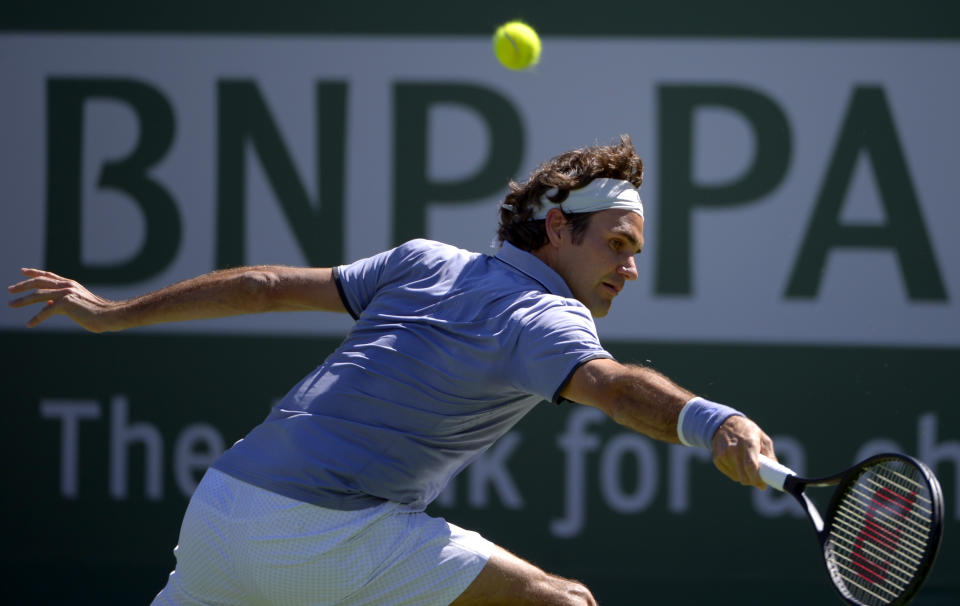 Roger Federer, of Switzerland, hits to Dmitry Tursunov, of Russia, during a third round match at the BNP Paribas Open tennis tournament, Monday, March 10, 2014, in Indian Wells, Calif. (AP Photo/Mark J. Terrill)