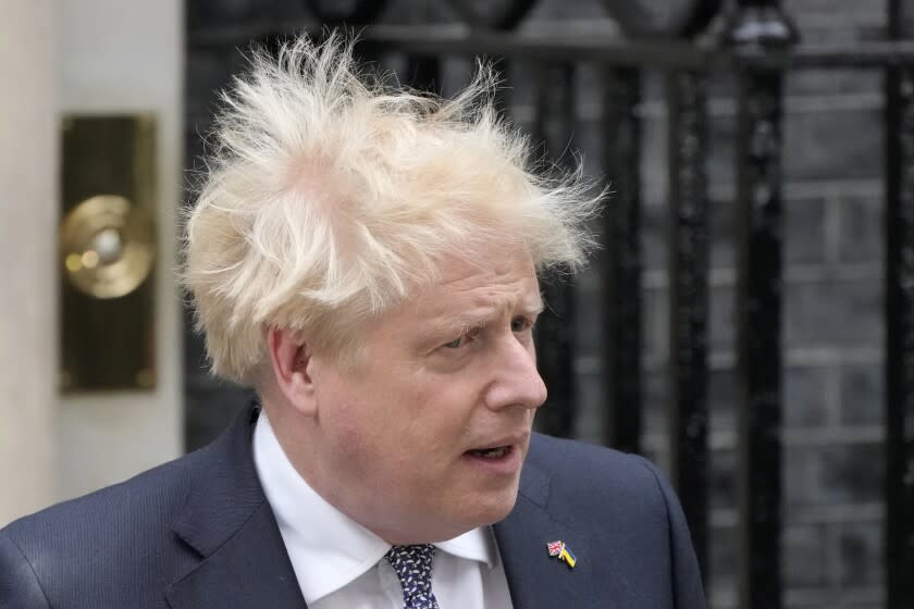 Prime Minister Boris Johnson arrives to read a statement outside 10 Downing Street, London, formally resigning as Conservative Party leader, in London, Thursday, July 7, 2022. Johnson said Thursday he will remain as British prime minister while a leadership contest is held to choose his successor. (AP Photo/Frank Augstein)