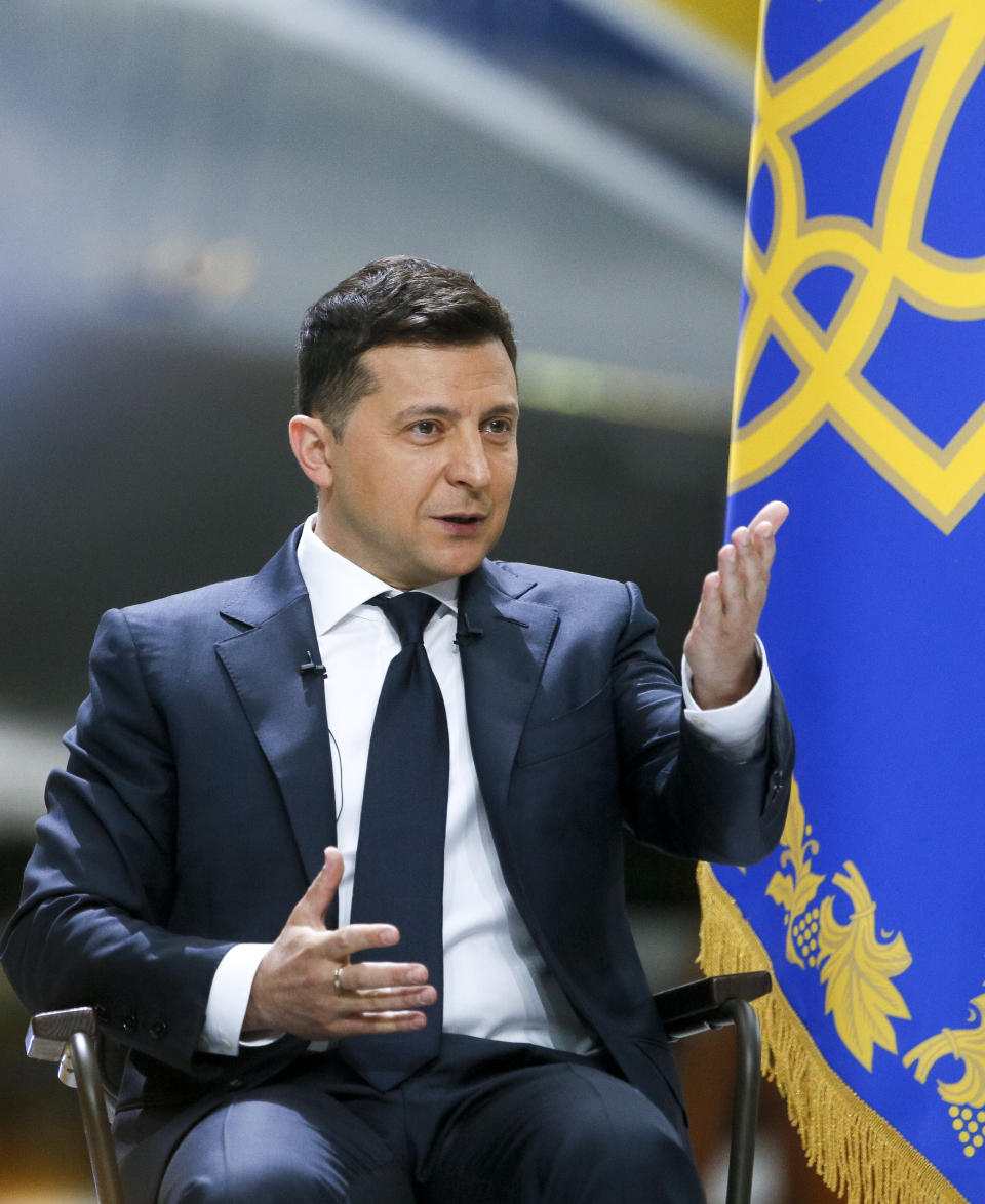 Ukrainian President Volodymyr Zelenskyy gestures while speaking to the media during a news conference with the world's largest airplane, Ukrainian Antonov An-225 Mriya in the background at the Antonov aircraft factory in Kyiv, Ukraine, Thursday, May 20, 2021. (AP Photo/Efrem Lukatsky)