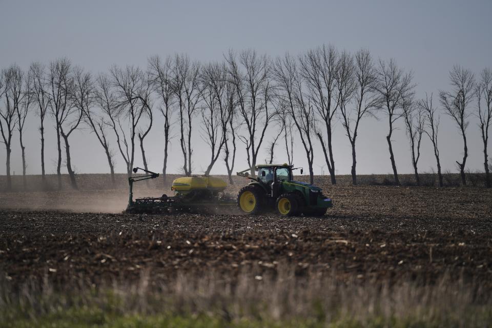 A crop farmer plants seed on a field in Lake Wilson, Minn., on Thursday, May 4, 2023. (AP Photo/Jessie Wardarski)