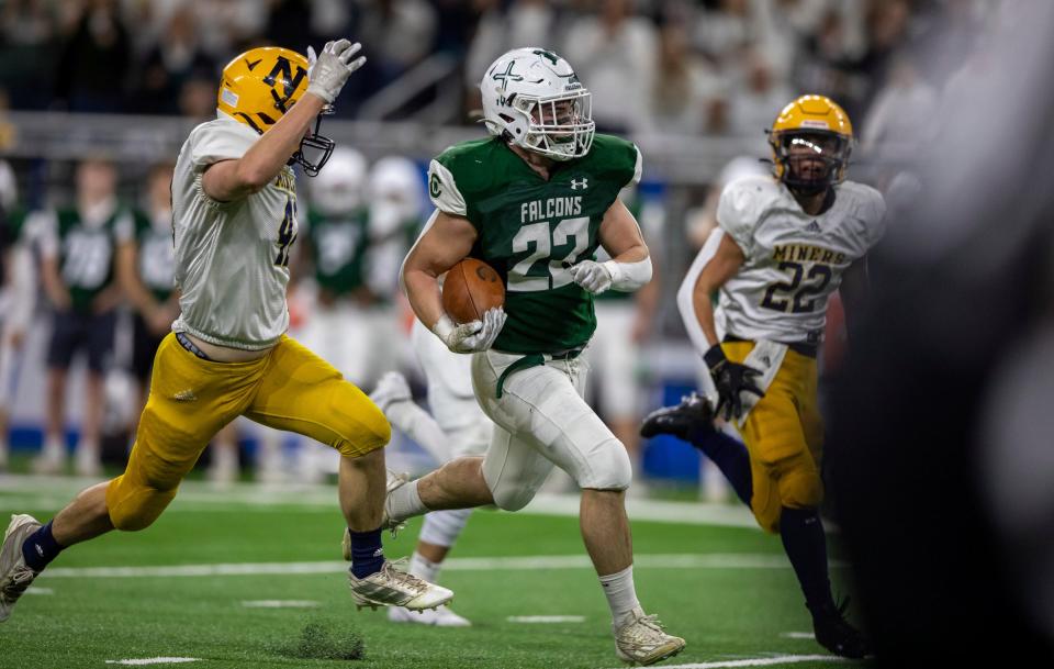 Grand Rapids West Catholic's Timmy Kloska runs through the Negaunee defense during the first half of West Catholic's 59-14 win in the Division 6 state finals on Friday, Nov. 25, 2022, at Ford Field.