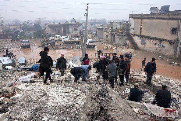 Residents sift through the rubble of a collapsed building, looking for victims and survivors, following an earthquake in the town of Jandaris, in the countryside of Syria's northwestern city of Afrin in the rebel-held part of Aleppo province, on February 6, 2023. - Hundreds have been reportedly killed in north Syria after a 7.8-magnitude earthquake that originated in Turkey and was felt across neighbouring countries. (Photo by Rami al SAYED / AFP) (Photo by RAMI AL SAYED/AFP via Getty Images)