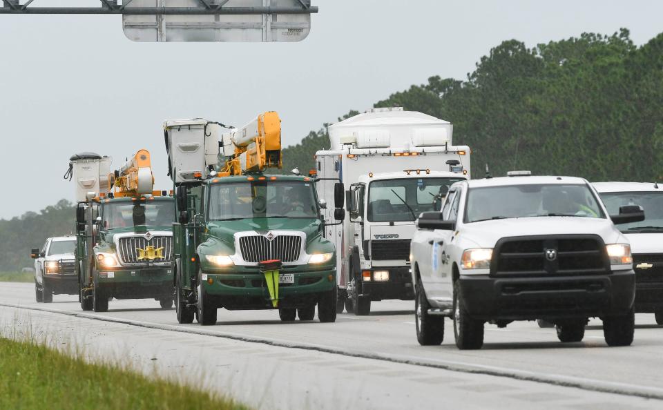 Utilities trucks head south on Interstate 95 to help restore power after Hurricane Dorian near Palm Bay, Fla.