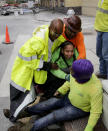 Workers are helped after a large portion of a hotel under construction suddenly collapsed in New Orleans on Saturday, Oct. 12, 2019. Several construction workers had to run to safety as the Hard Rock Hotel, which has been under construction for the last several months, came crashing down. It was not immediately clear what caused the collapse or if anyone was injured. (Scott Threlkeld/The Advocate via AP)