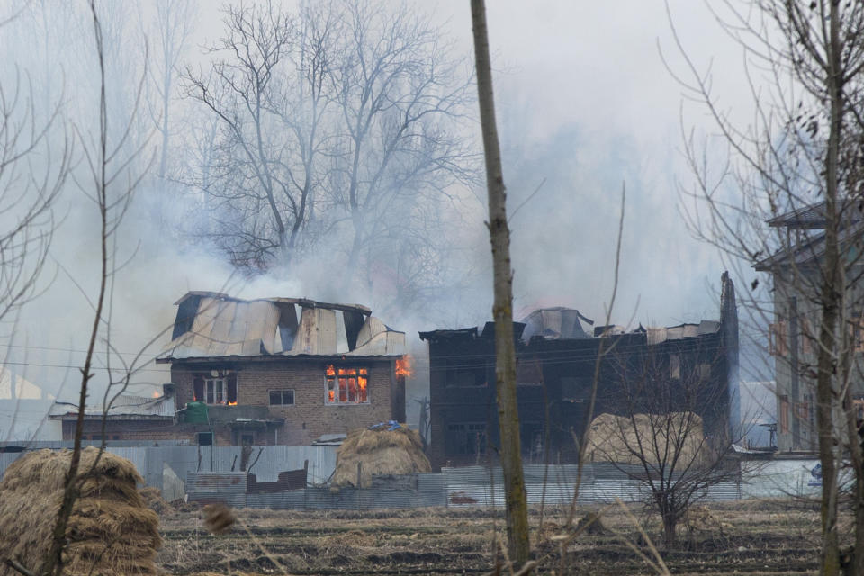 Flames and smoke billows from residential buildings where militants are suspected to have taken refuge during a gun battle in Pulwama, south of Srinagar, Indian controlled Kashmir, Monday, Feb. 18, 2019. Tensions continued to rise in the aftermath of a suicide attack in disputed Kashmir, with seven people killed Monday in a gunbattle that broke out as Indian soldiers scoured the area for militants. (AP Photo/ Dar Yasin)