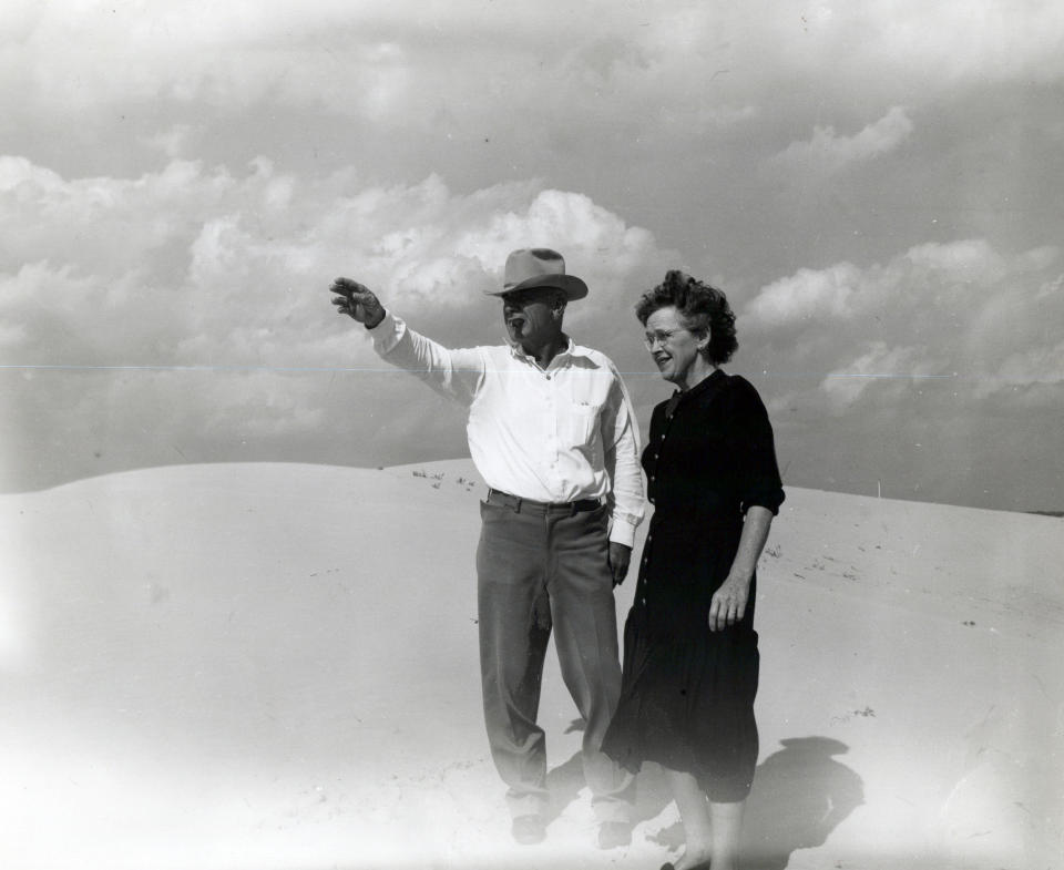 This undated family photo provided by Ashley Williams Watt shows Watt's great-grandfather, Glen Joseph Allen, and his wife, Helen, surveying land in West Texas. Allen was a cow buyer in Fort Worth and eventually moved to sandy terrain in the Permian Basin to raise cattle. His great-granddaughter, Ashley Williams Watt, is carrying on in their tradition — but worries that pollution from abandoned oil wells on some of her land may threaten the legacy. "What if that history ends with me?" Watt says. (Watt Family via AP)