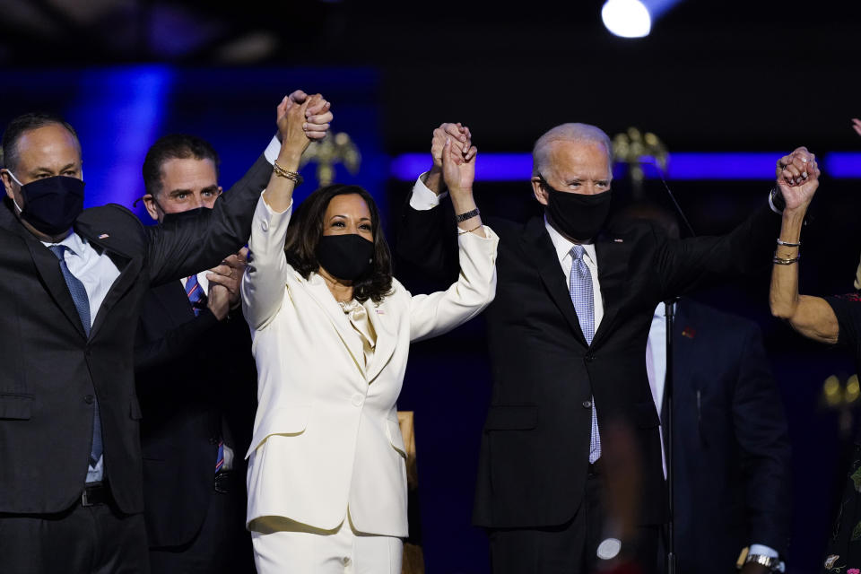 President-elect Joe Biden, his wife Jill Biden, and members of the Biden family, along with Vice President-elect Kamala Harris, her husband Doug Emhoff stand on stage Saturday, Nov. 7, 2020, in Wilmington, Del. (AP Photo/Andrew Harnik)