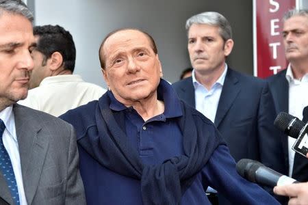 Italian tycoon and former prime minister Silvio Berlusconi talks with reporters as he leaves the hospital after a heart surgery in Milan, Italy July 5, 2016. REUTERS/Flavio Lo Scalzo