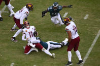 Washington Commanders quarterback Carson Wentz (11) is sacked by Philadelphia Eagles defensive end Josh Sweat (94) during the second half of an NFL football game, Sunday, Sept. 25, 2022, in Landover, Md. (AP Photo/Nick Wass)