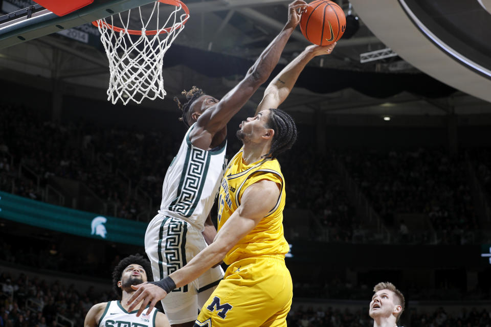 Michigan State forward Coen Carr, left, blocks a shot by Michigan forward Olivier Nkamhoua during the first half of an NCAA college basketball game, Tuesday, Jan. 30, 2024, in East Lansing, Mich. (AP Photo/Al Goldis)