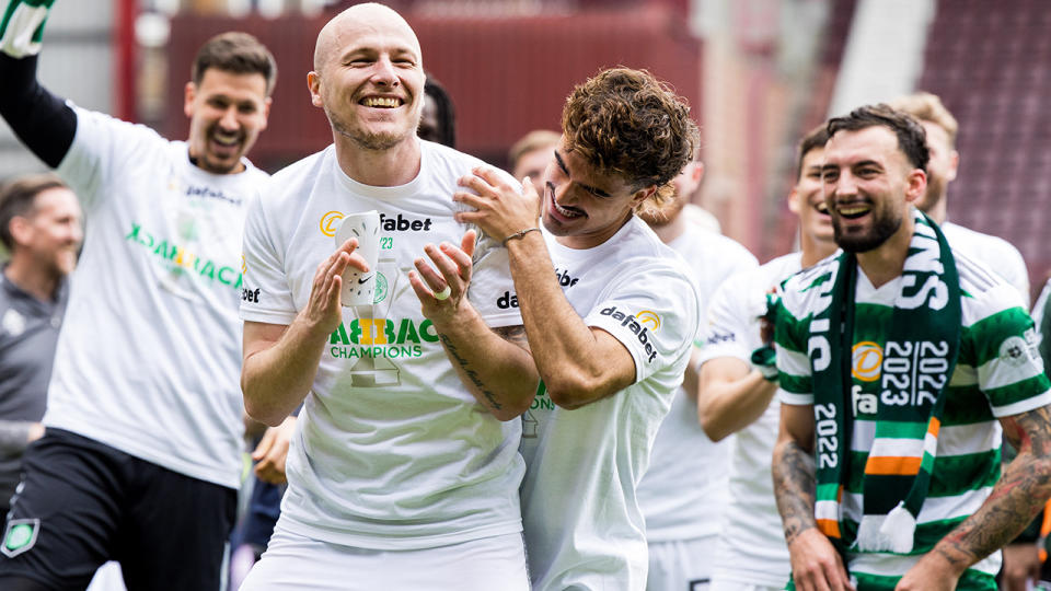 Aaron Mooy is mobbed by Celtic FC teammates.