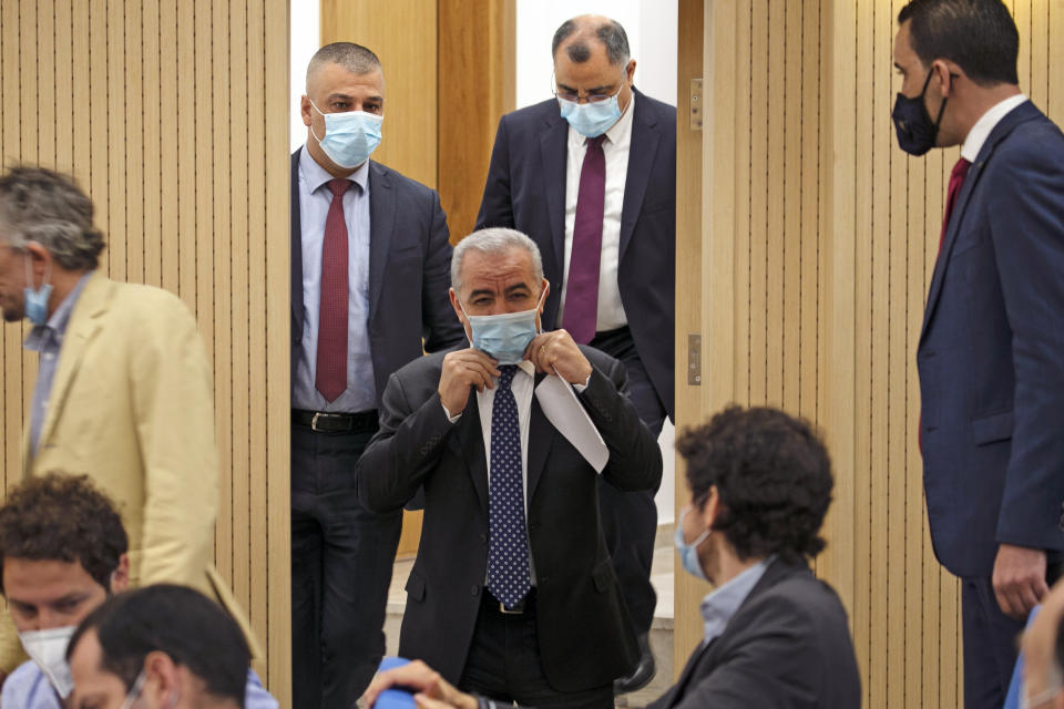 Palestinian Prime Minister Mohammad Shtayyeh arrives in a protective mask for a press conference at the Foreign Press Association in the West Bank city of Ramallah, on Tuesday, June 9, 2020. The Palestinians said Tuesday they proposed a demilitarized Palestinian state in the West Bank, Gaza and east Jerusalem with one-to-one land exchanges with Israel as a counteroffer to President Donald Trump’s Mideast plan. Shtayyeh declined to provide further details about the 4 1/2-page proposal but said the Palestinian position on major issues is well-known. (Abbas Momani/Pool Photo via AP)