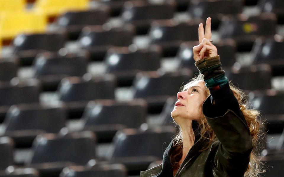 A supporter of Borussia Dortmund reacts at the stadium in Dortmund - Credit: EPA