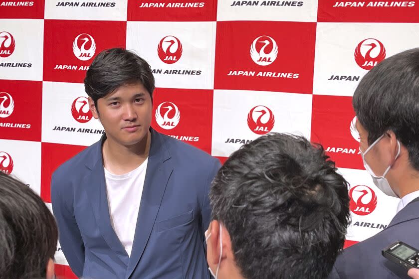 Los Angeles Angels' Shohei Ohtani speaks to reporters after he returned home, at the Haneda international airport in Tokyo