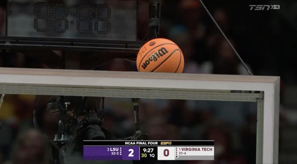 The ball gets stuck above the backboard early in the LSU-Virginia Tech Final Four matchup.