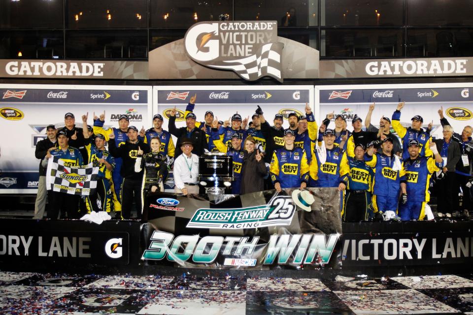 DAYTONA BEACH, FL - FEBRUARY 27: Matt Kenseth, driver of the #17 Best Buy Ford, poses in Victory Lane with wife Katie and team owner Jack Rough after getting Roush\