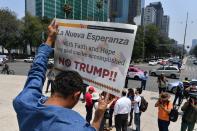 <p>Central American migrants takes part in the “Migrant Via Crucis” caravan towards the United States, and participate in a protest against the policies of US President Donald Trump in front of the US embassy bulding in Mexico City on April 7, 2018. (Photo: Yuri Cortez/AFP/Getty Images) </p>