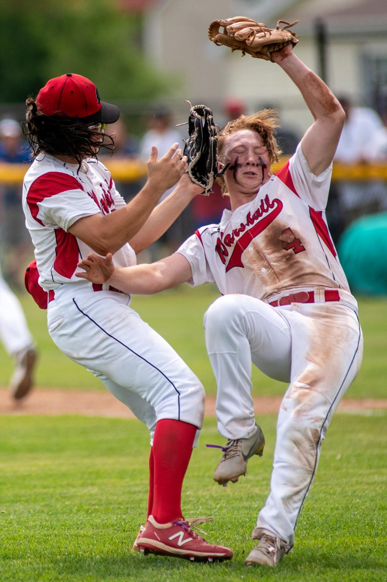 Marshall sophomores Killian Bies (3) and Luke Holbrook (4) collide while catching the ball on Saturday, June 12, 2021 at Coldwater High School. Grand Rapids South Christian defeated Marshall 8-0. 