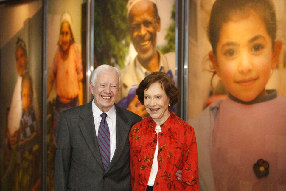 FILE - In this Sept. 28, 2009, file photo former President Jimmy Carter and his wife Rosalynn look at a new interactive exhibit at the Jimmy Carter Library and Museum in Atlanta. Jimmy Carter and his wife Rosalynn celebrate their 75th anniversary this week on Thursday, July 7, 2021. (AP Photo/John Bazemore, File)