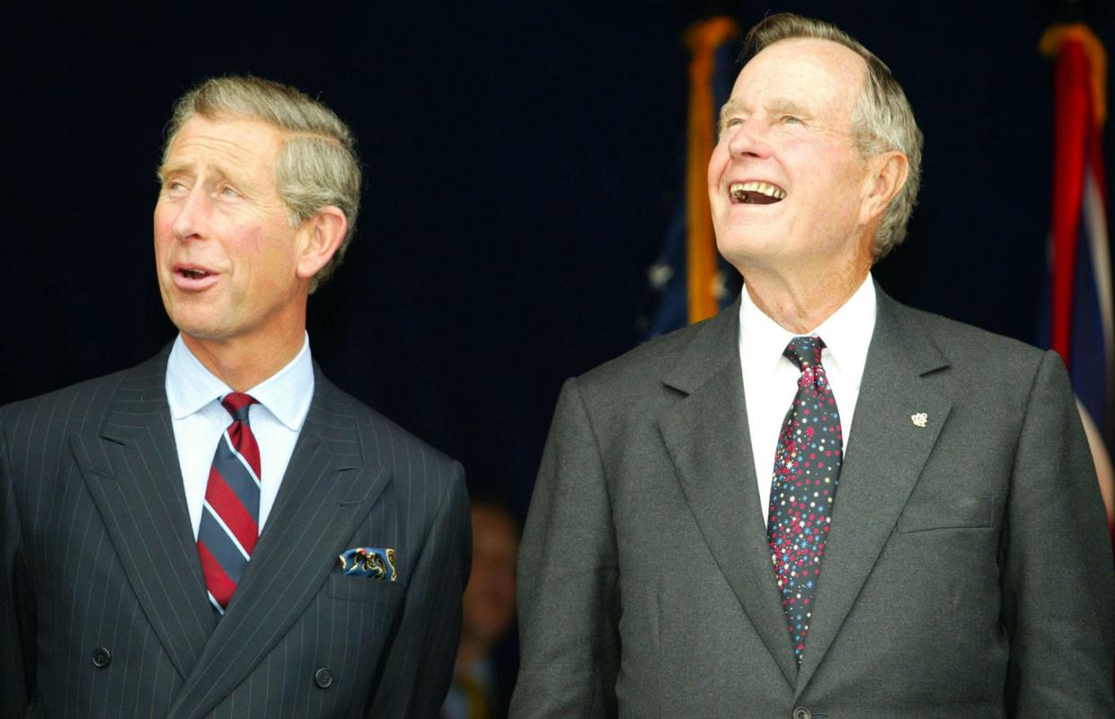 Prince Charles and George Bush watch a flypast