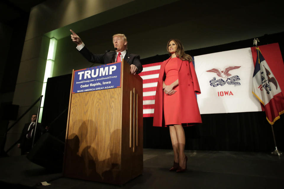 Melania Trump with a red coat draped over her shoulders in 2015