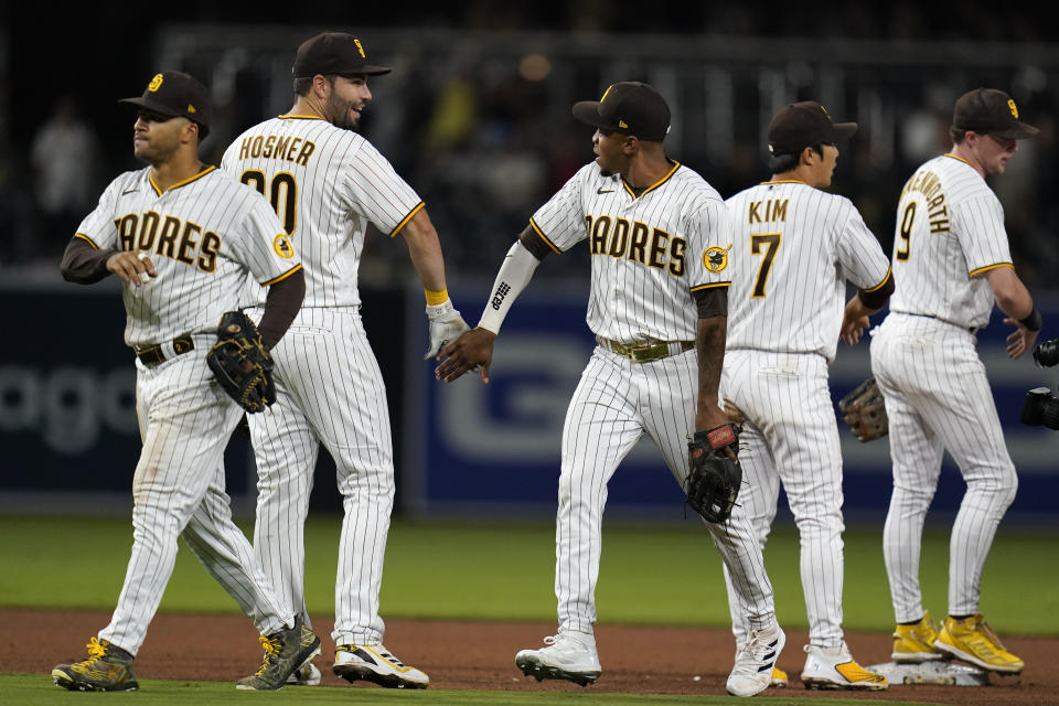 San Diego Padres right fielder Jose Azocar, third from left, celebrates with teammate first baseman Eric Hosmer and others after the Padres defeated the Colorado Rockies 9-0 in a baseball game Friday, June 10, 2022, in San Diego. (AP Photo/Gregory Bull)