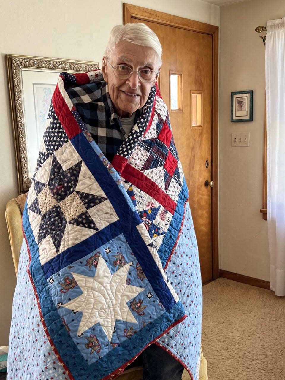 Noble Hand displays the Quilt of Valor he received in November in recognition of his service during World War II.