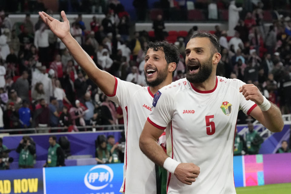 Jordan's Bara Marie, left, and Jordan's Yazan Alarab celebrate after the Asian Cup semifinal soccer match between South Korea and Jordan at Ahmad Bin Ali Stadium in Al Rayyan, Qatar, Tuesday, Feb. 6, 2024. Jordan won 2-0. (AP Photo/Aijaz Rahi)