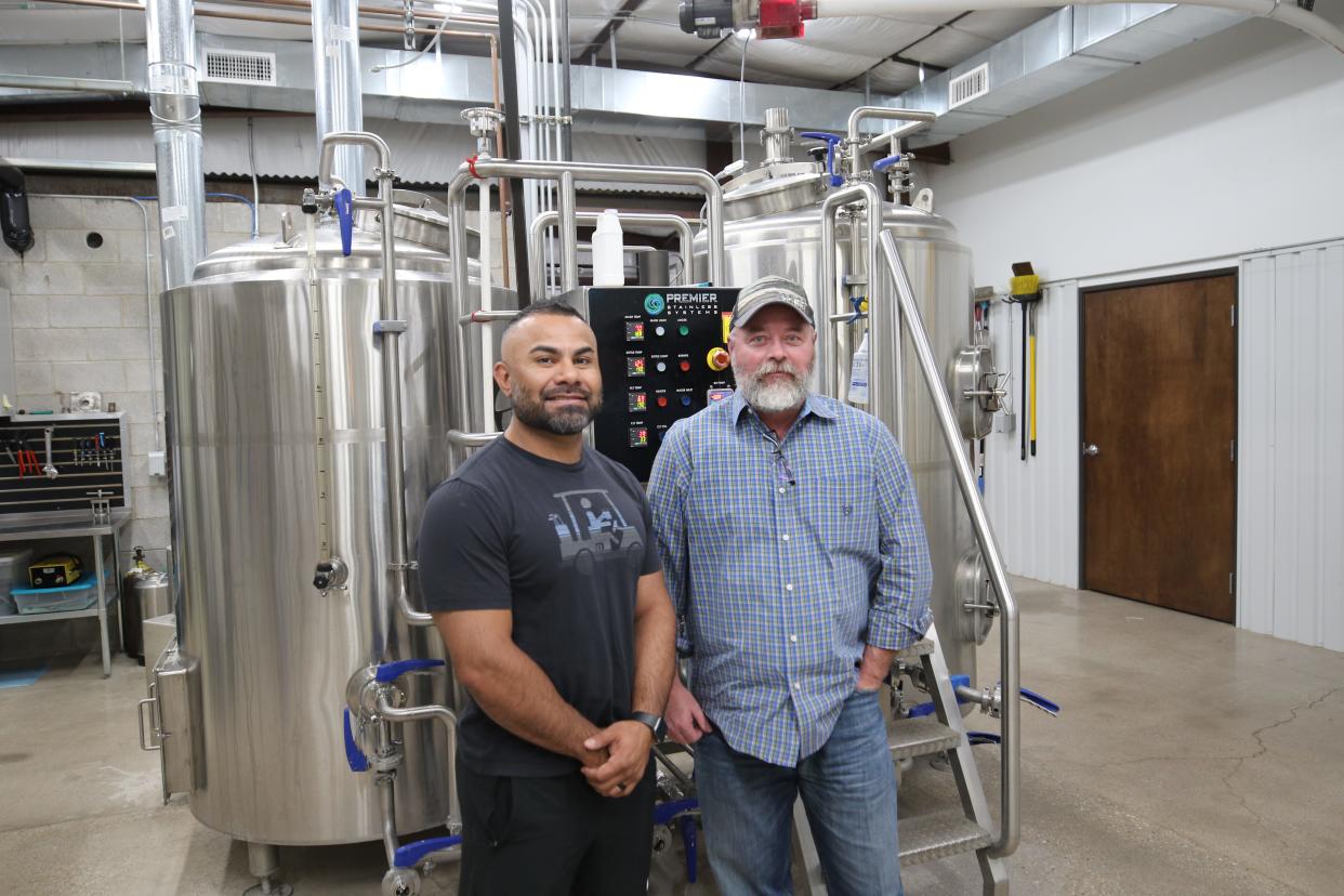 Owners David Vasquez (left) and Jason Maley are pictured in front of brewing cask, April 19, 2024 at Guadalupe Mountain Brewing Company.