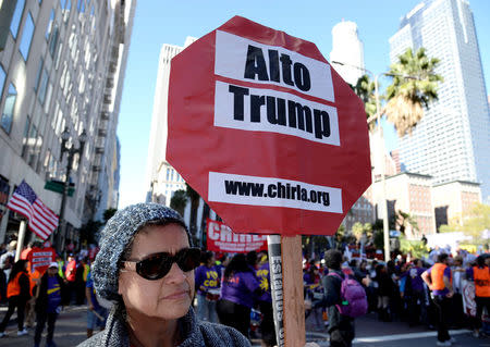 Protesters hold up signs during a march and rally against the United States President-elect Donald Trump in Los Angeles, California, U.S. December 18, 2016.REUTERS/Kevork Djansezian