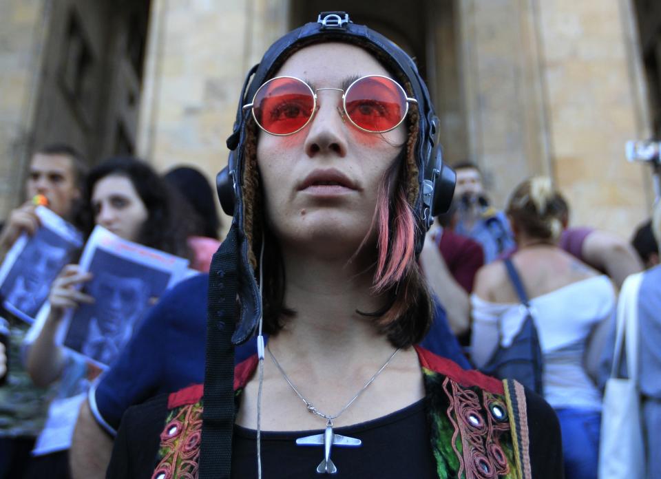 An opposition demonstrator attends a rally in front of the Georgian Parliament building in Tbilisi, Georgia, Monday, June 24, 2019. Demonstrators have returned to parliament for daily rallies, demanding the release of detained protesters, the ouster of the nation's interior minister and changes in the electoral law to have legislators chosen fully proportionally rather than the current mix of party-list and single-mandate representatives. (AP Photo/Shakh Aivazov)