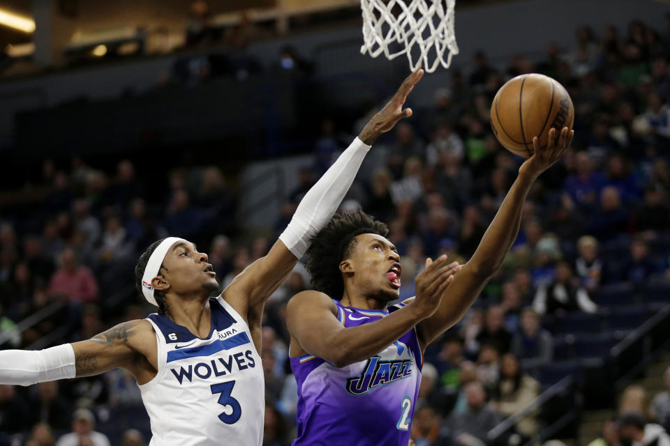 Utah Jazz guard Collin Sexton (2) shoots in front of Minnesota Timberwolves forward Jaden McDaniels (3) in the first quarter of an NBA basketball game, Monday, Jan. 16, 2023, in Minneapolis. (AP Photo/Andy Clayton-King)