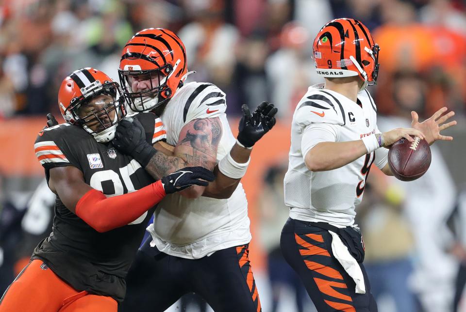 Bengals quarterback Joe Burrow passes under pressure from Browns defensive end Myles Garrett during the second half Monday, Oct. 31, 2022, in Cleveland.