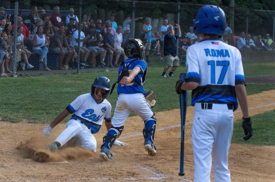 Toms River East Cole Garrison slides safely into home in the fourth inning for his team’s second run of game. Toms River East Little League shuts out Sunnybrae 3-0 to win Section 3 Championship in Hamilton, NJ on July 23, 2021. 