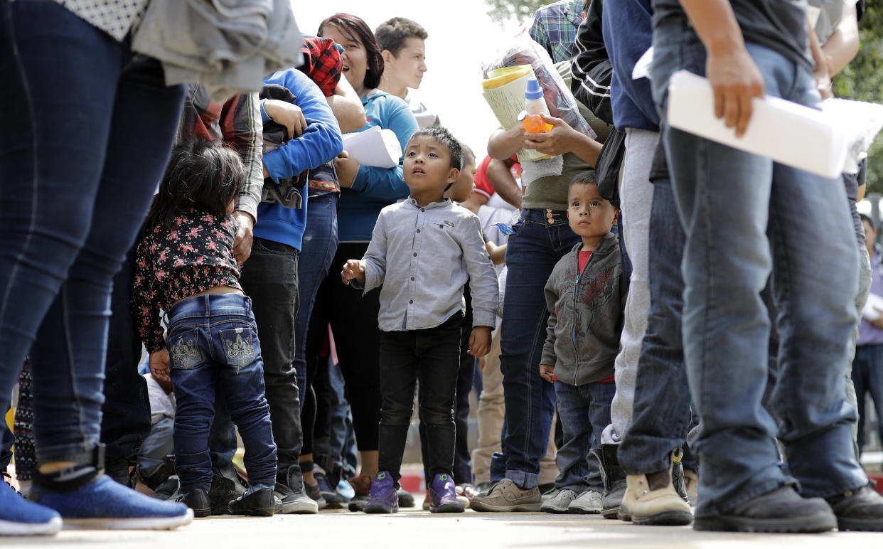 Immigrant families line up to enter bus station after being processed and released by U.S. Customs and Border Protection on June 24, 2018, in McAllen, Texas. (Photo: David J. Phillip/AP)