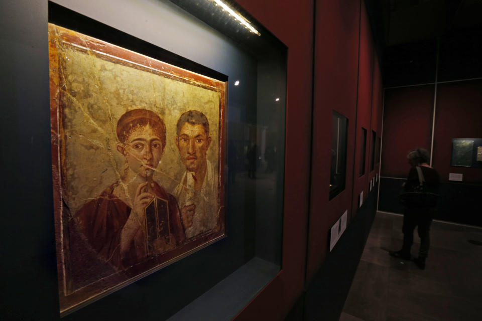 A fresco showing the baker Terentius Neo and his wife, found in the ruins of Pompeii, is seen during a photo call for the upcoming exhibition entitled 'Life and death Pompeii and Herculaneum', at the British Museum in central London, Tuesday, March 26, 2013. The exhibition about the two Roman cities, buried by a catastrophic volcanic eruption of Mount Vezuvius in 79 AD, will run at the museum from March 28 to Sept. 29, 2013. (AP Photo/Lefteris Pitarakis)